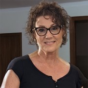 Cindy Fine Woman with curly, dark hair and glasses